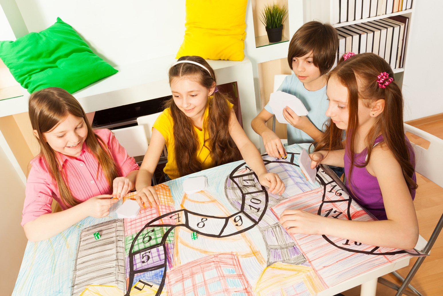 Top View of Four Kids Playing the Tabletop Game